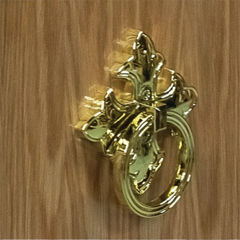 Ornate brass ring handle mounted on the oak veneered side of The Dalbury
